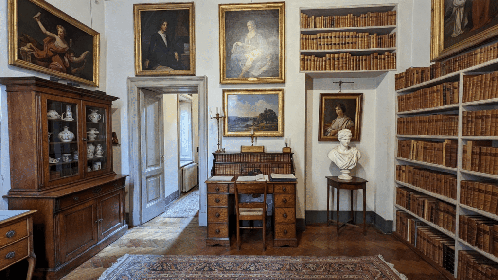 Interior of the Keats-Shelley House in Rome featuring antique furniture and literary artifacts.